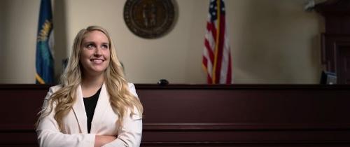 A pre-law student standing in a courtroom